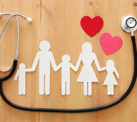 Health Insurance . concept image of Stethoscope and family on wooden table. top view